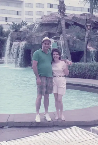 Mario R. Alvarez, Sr. by a resort pool and waterfall