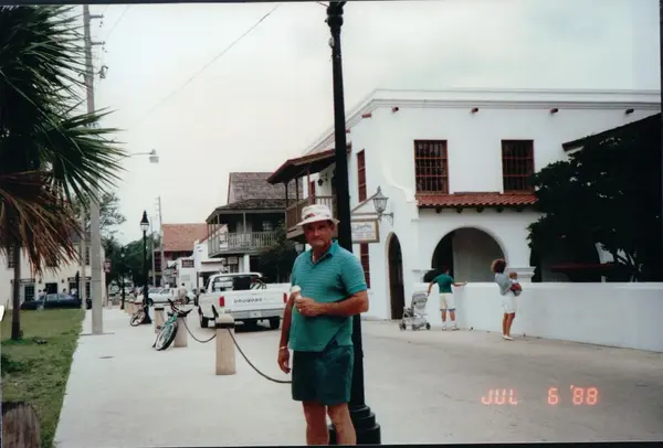 Mario R. Alvarez, Sr. on a palm-lined street